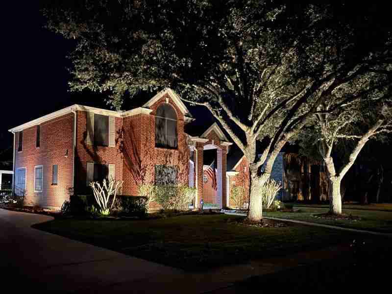Illuminated house with surrounding trees